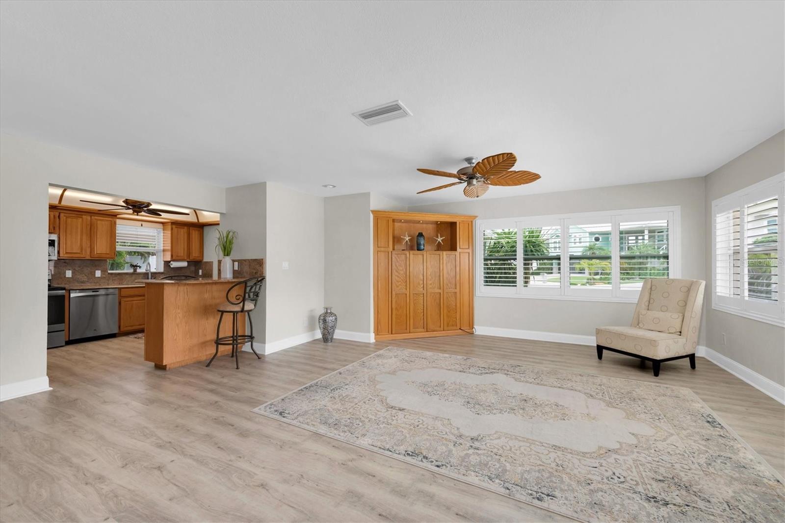 Spacious living room with plenty of natural light. Plantation shutters on every window