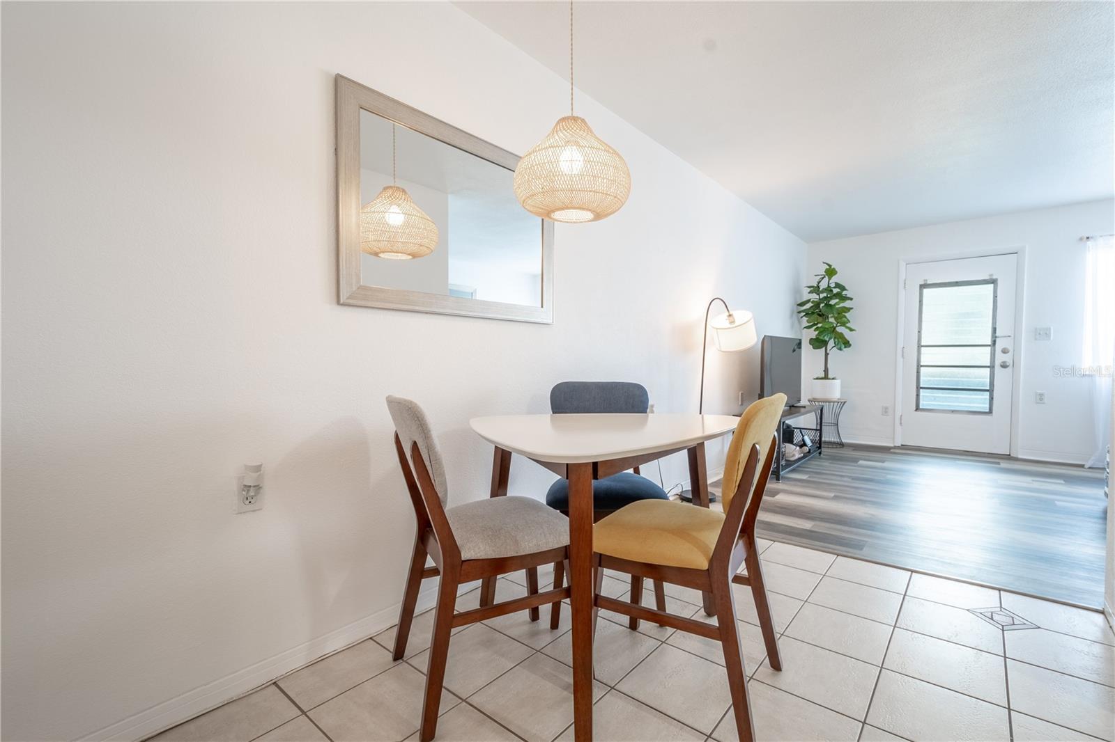 The living room is open to the dinette which features a charming pendent light that hangs above your dining table.