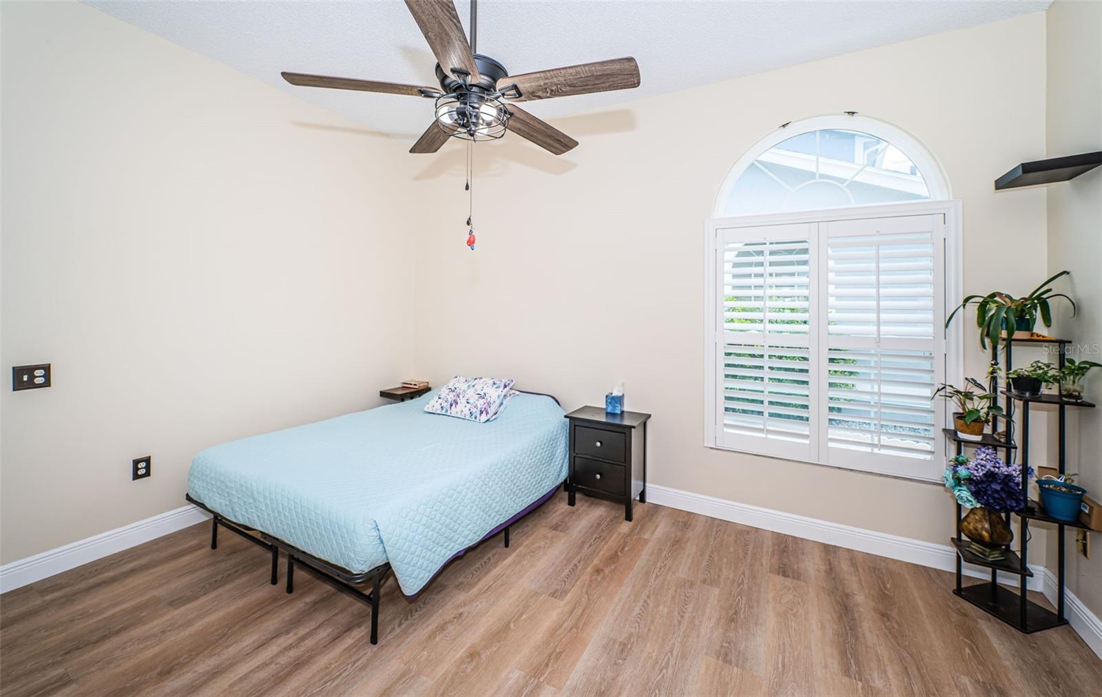 Downstairs Primary Bedroom - plantation shutters and impact rated windows