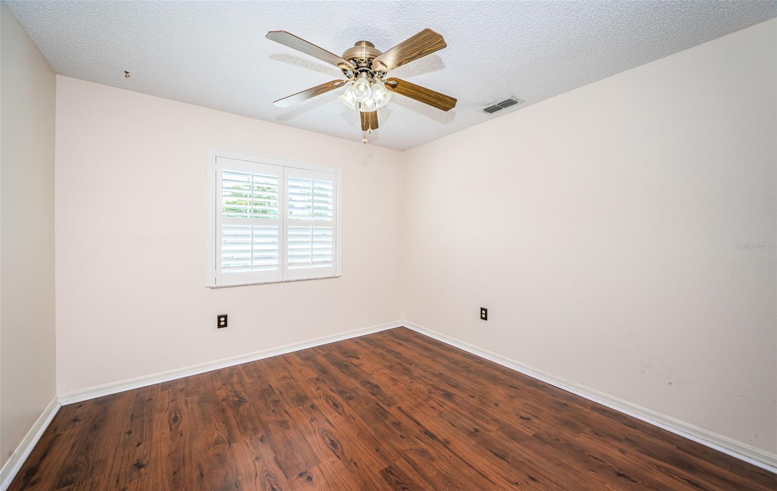 Upstairs Bedroom #2 - plantation shutters, impact rated window