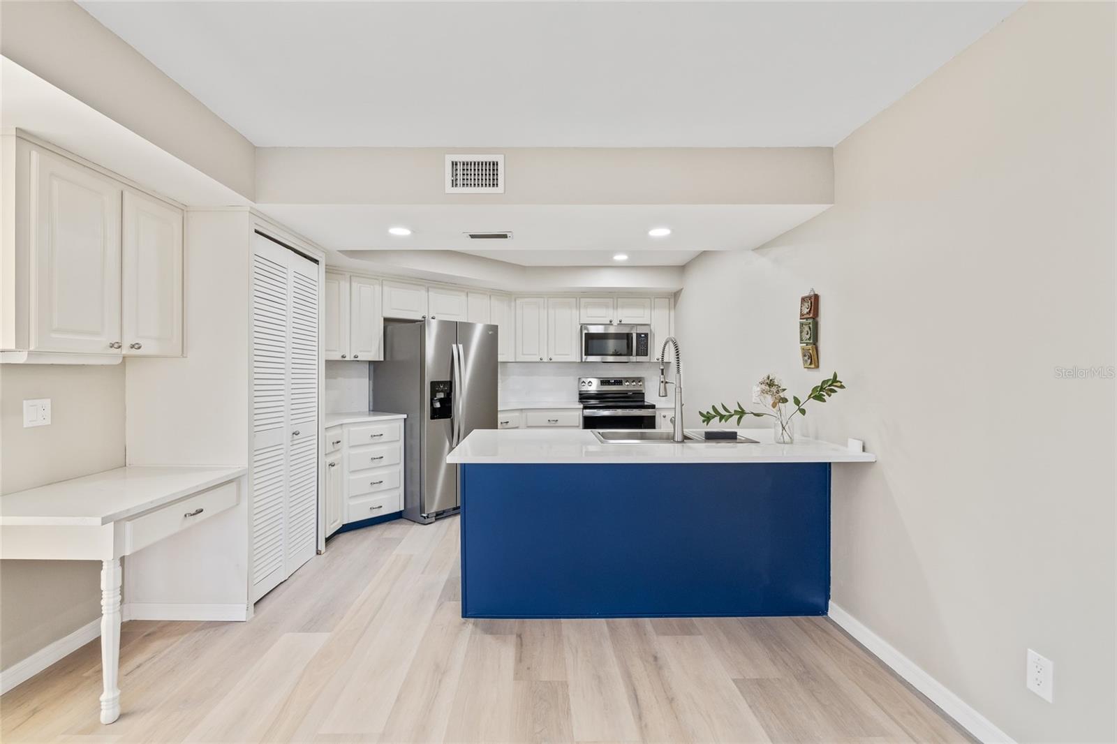 New Kitchen Island with Quartz countertops, Stainless Steel appliances , Sink, faucet and lighting.