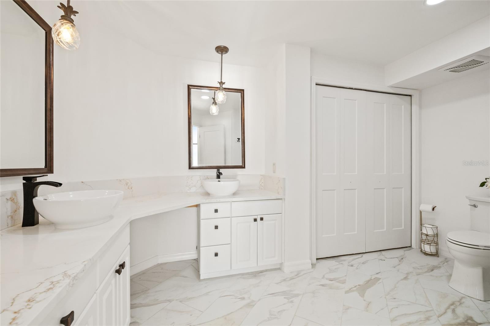 En suite bathroom in the primary. Newly renovated with dual sinks and Italian Porcelain tile