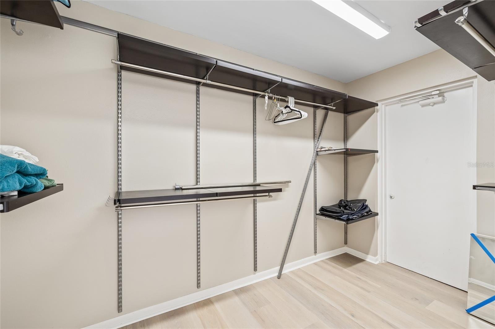 Walk In Closet in the primary with custom built in shelving