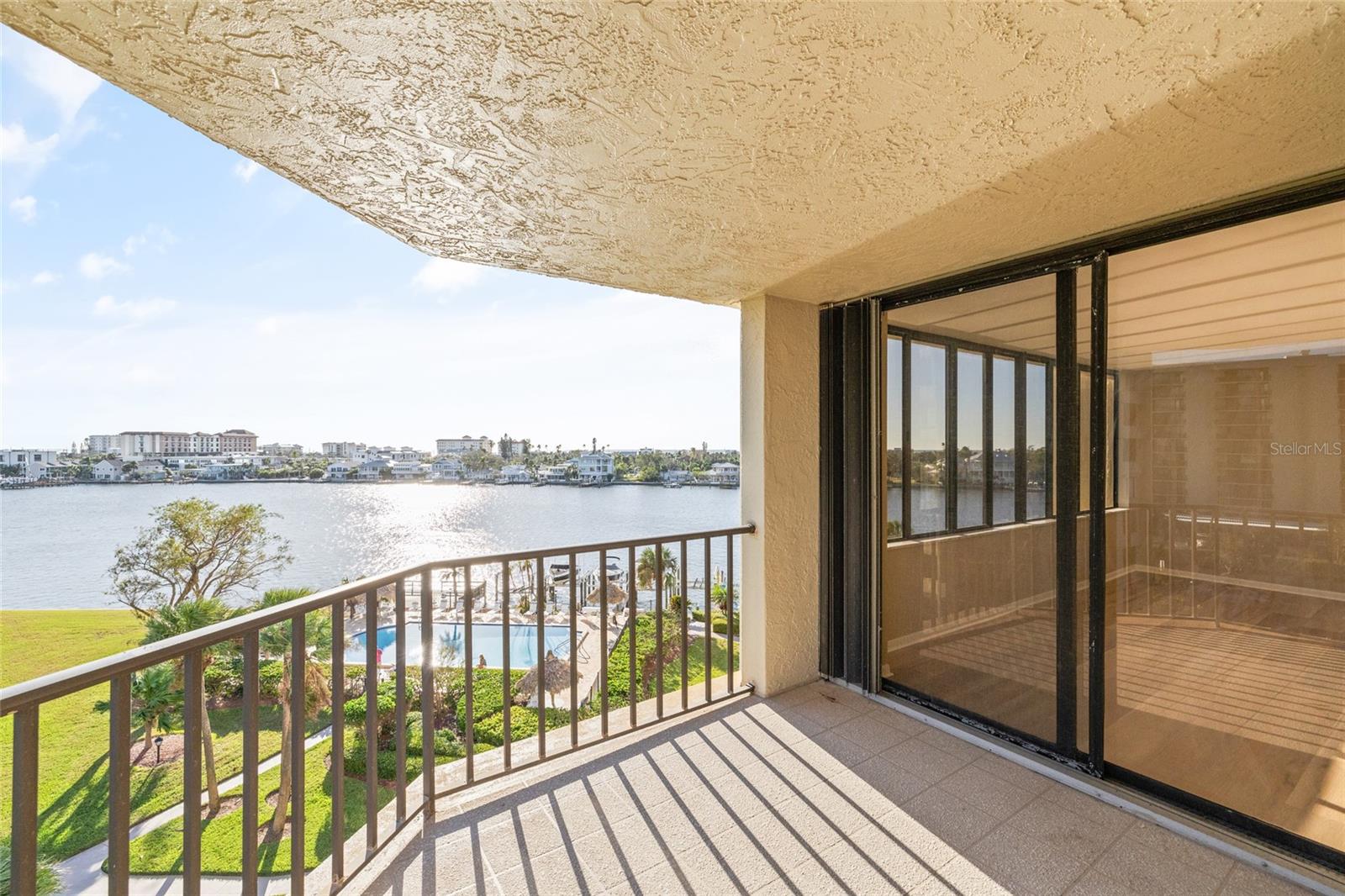 Corner unit balcony overlooking the pool and Intercoastal waterway- Perfect for catching the sunset and dolphin watching!