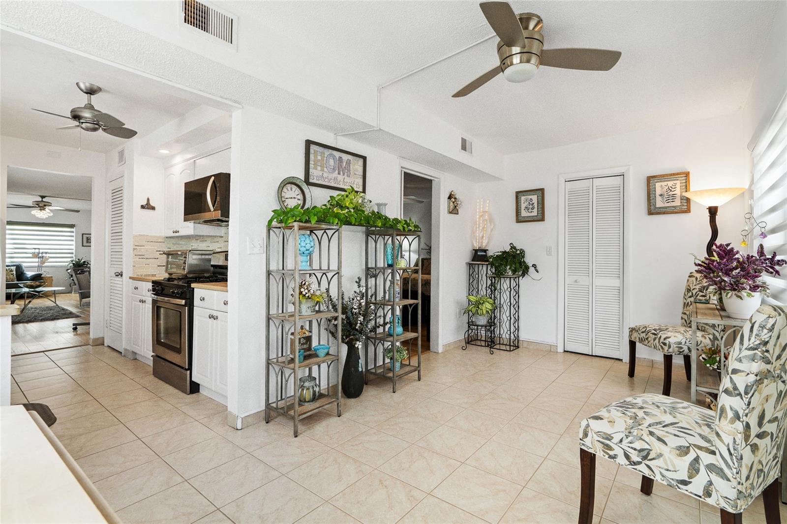 Family room/sitting room/bonus room... this room has a walk-in storage closet, open door between the kitchen and closet is the Primary bedroom