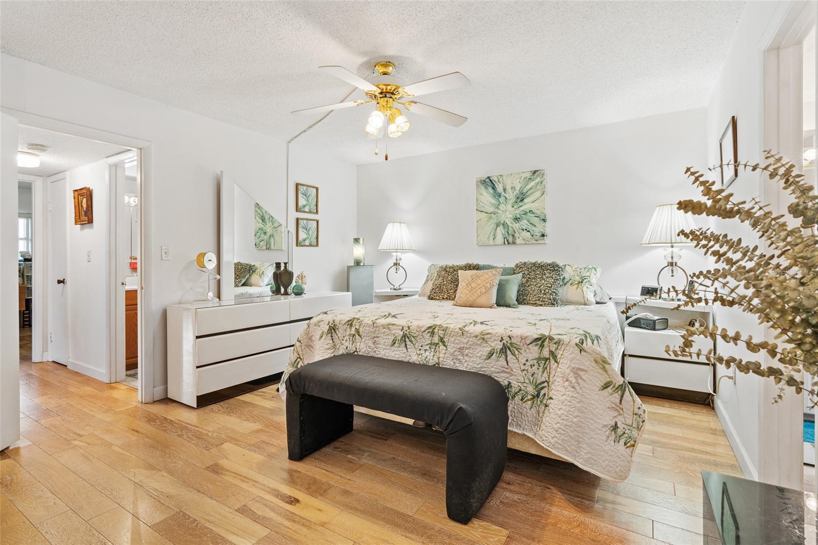 Primary bedroom, real wood floors run through the living area, ceramic tile in the wet areas only.