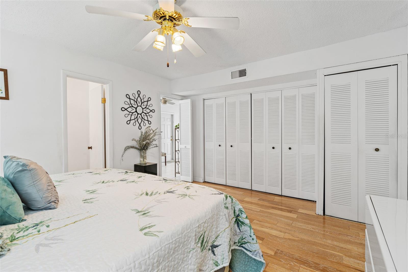 Primary bedroom - wall to wall closet/storage. Open door to the left is the bathroom, door to the right opens up to the Family room