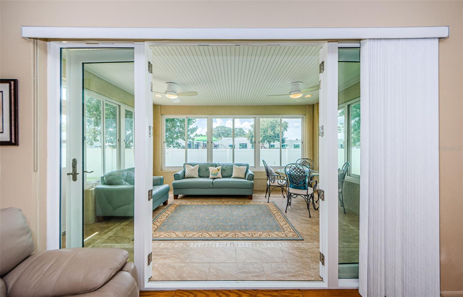 Sunroom Featuring Acrylic Windows & Two Ceiling Fans