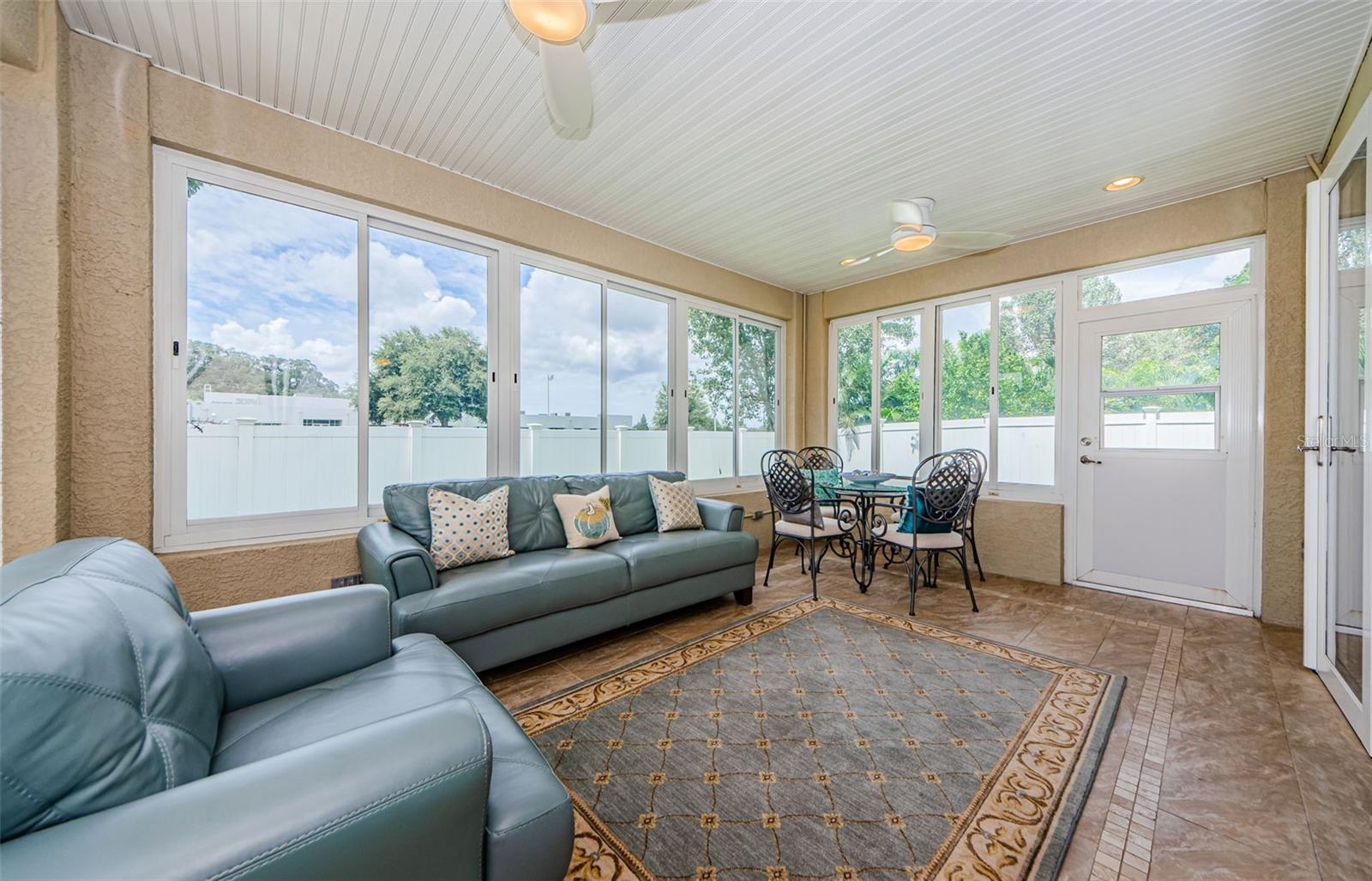 Sunroom Featuring Acrylic Windows & Two Ceiling Fans