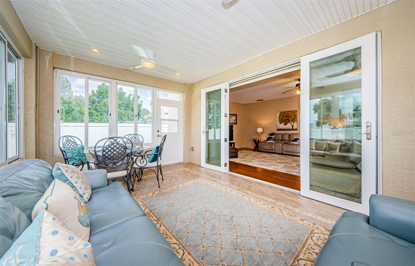 Sunroom Featuring Acrylic Windows & Two Ceiling Fans