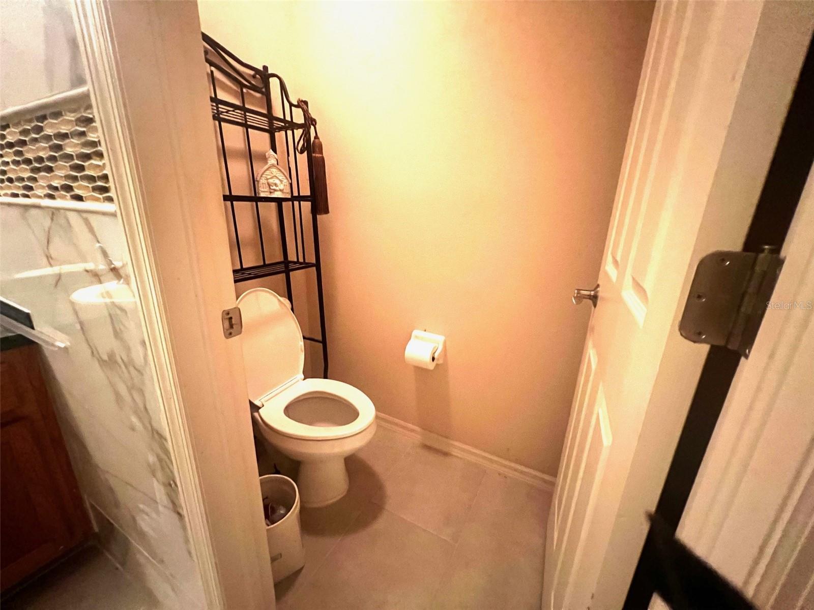 Toilet in Master Bathroom with private door