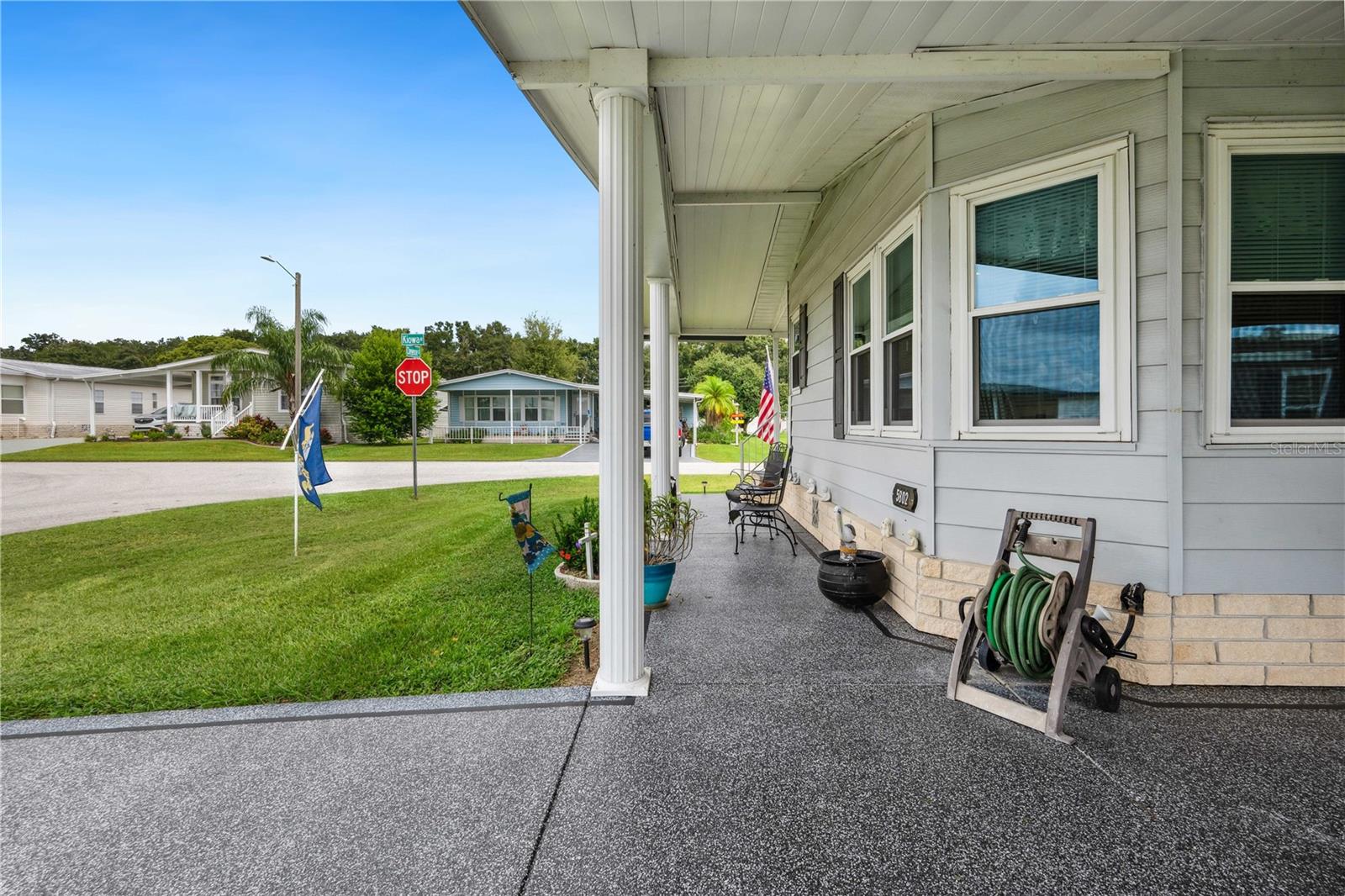 Painted driveway on this oversized carport home.