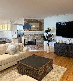 view from staircase.  Can see lighted cabinets over island in kitchen.