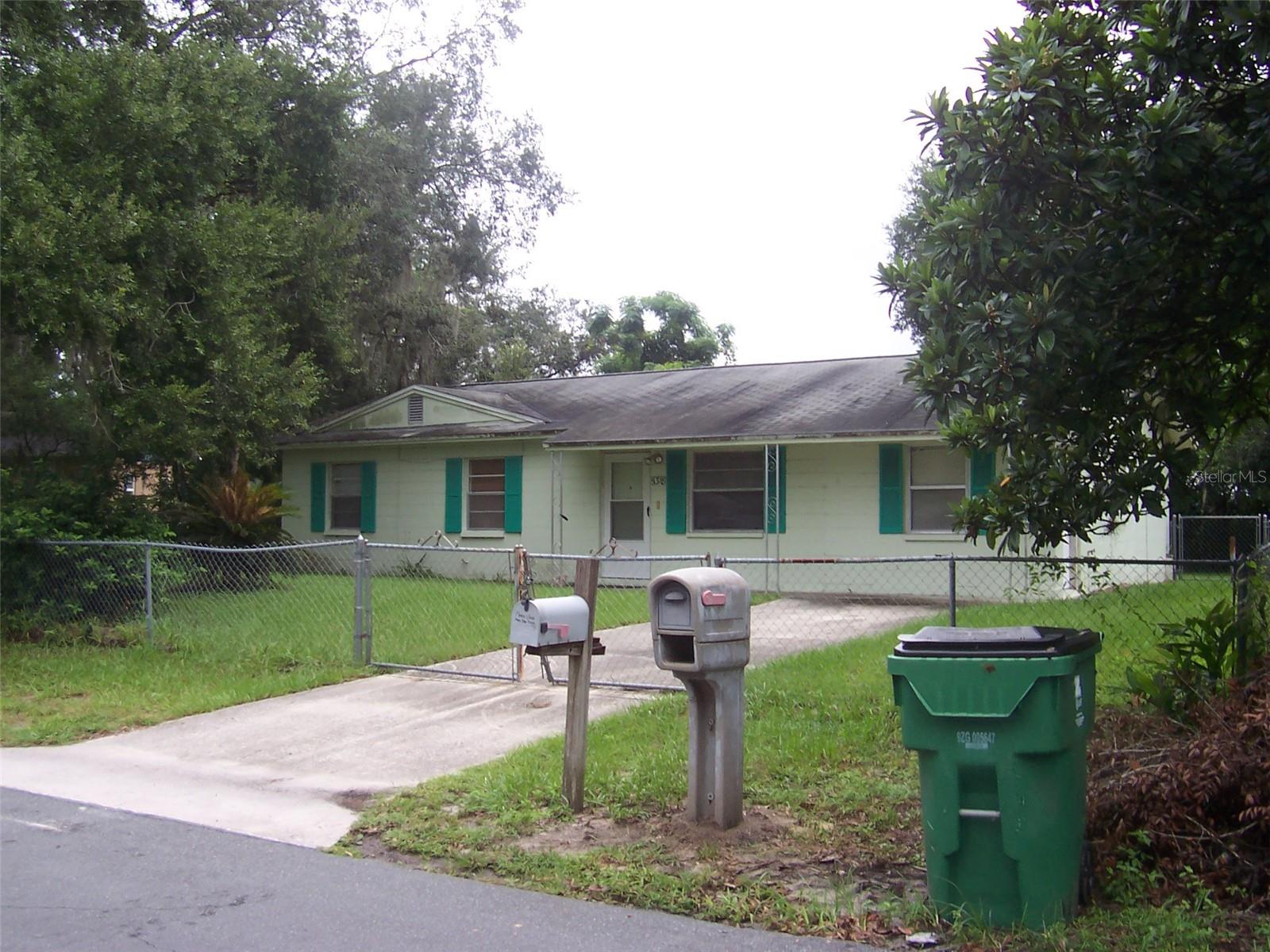 Street View showing gated and fenced front yard.