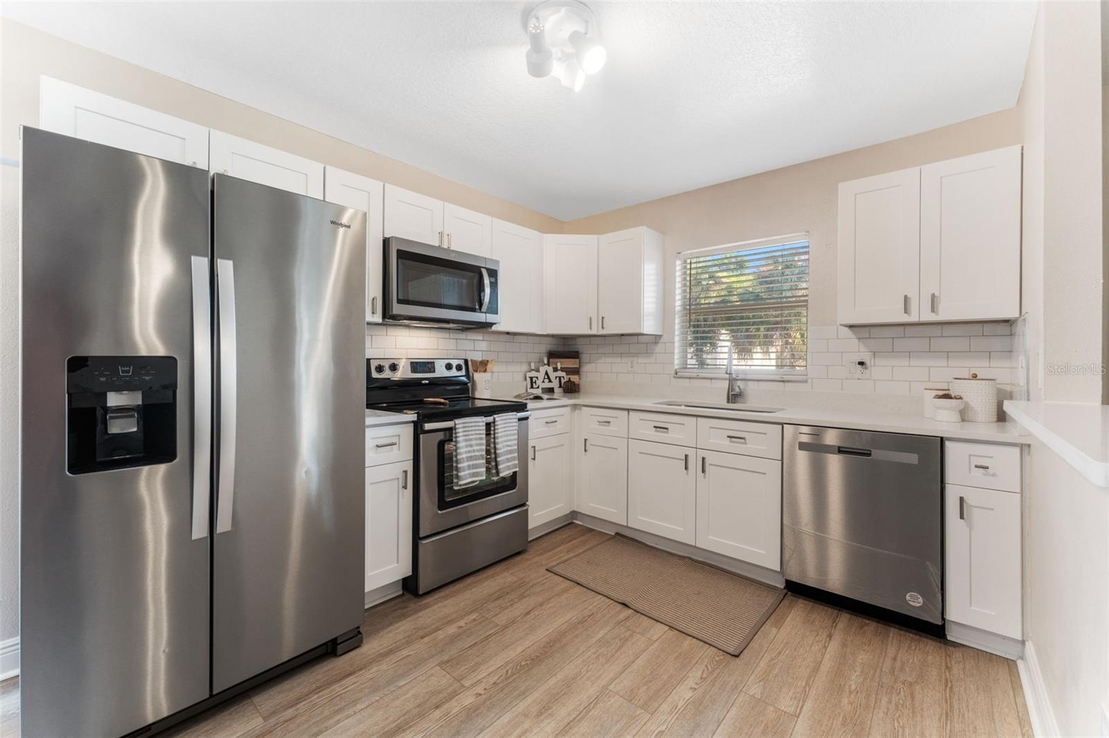 Everyone Loves A Beautiful White Kitchen With New Stainless Steel Appliances