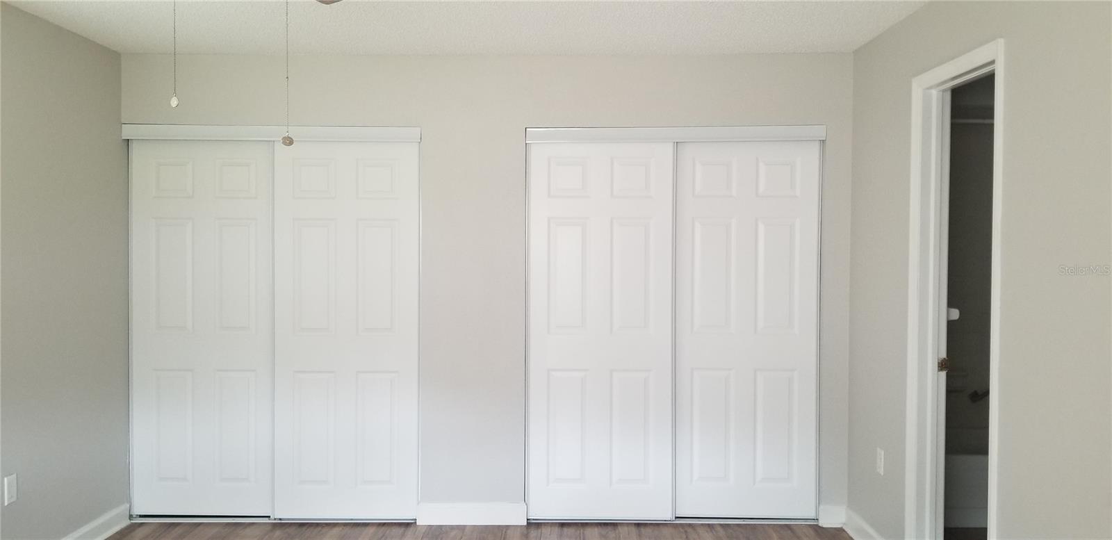 full wall closet with newer doors