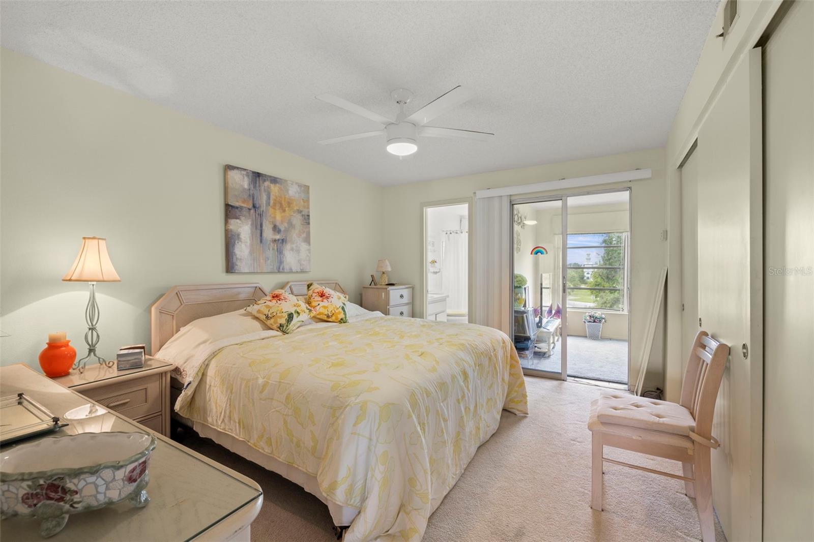 The large, primary bedroom can easily accommodate a king-sized bed and features double built-in closets, neutral paint tones, ceiling fan, plush carpeting and also has an en-suite bathroom.