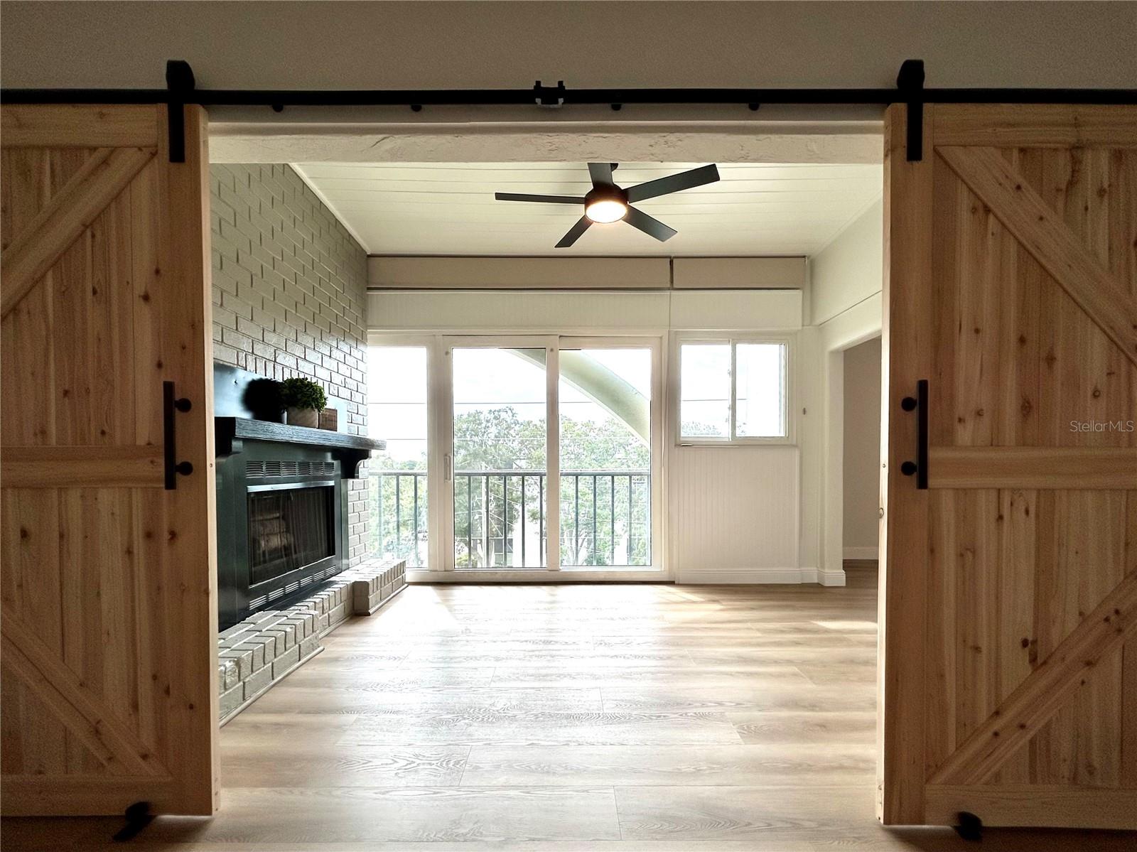 Double Barn-Doors allow bonus area with fireplace to be open or closed to Primary Bedroom