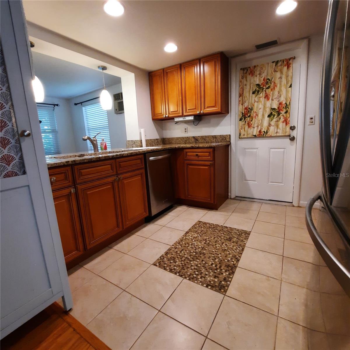 Granite counters, wood cabinets and modern stainless steel appliances