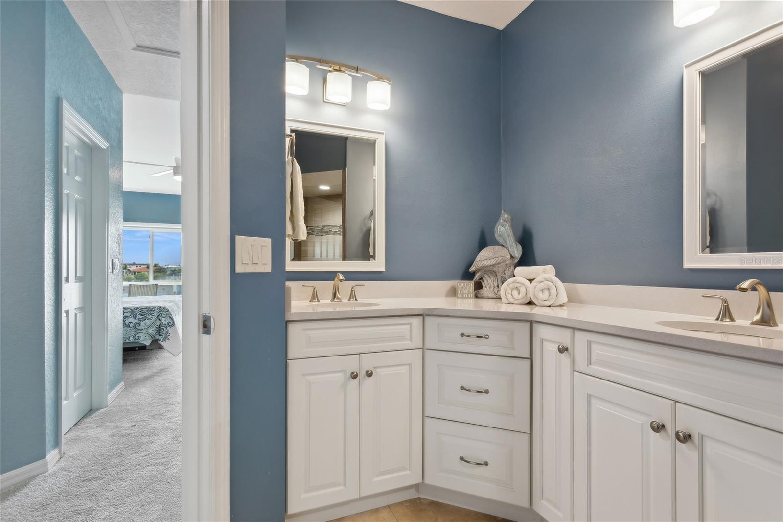 Primary bathroom with dual sinks and walk-in shower