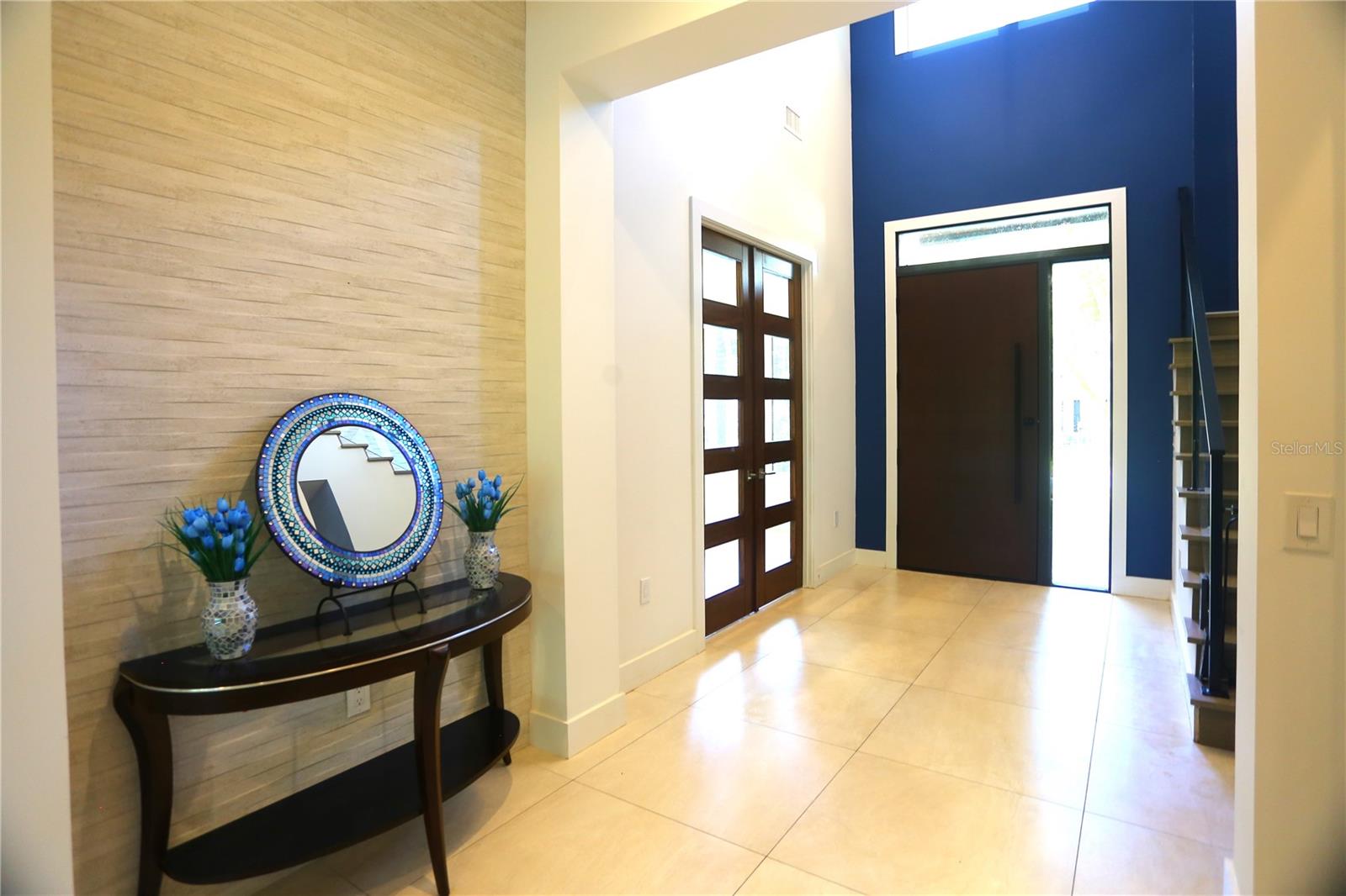 Foyer.  Beautiful wooden glass doors to the left of the picture lead to bonus room perfect for whatever you would like.