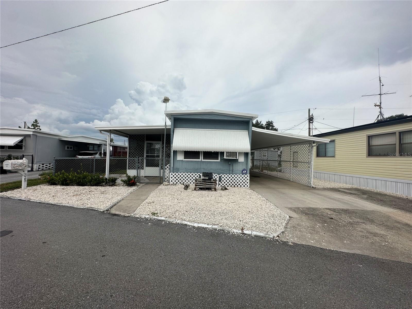 Front of house, carport and extra parking pad.