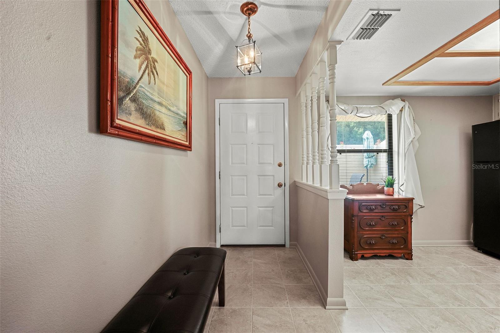 Foyer and view into kitchen