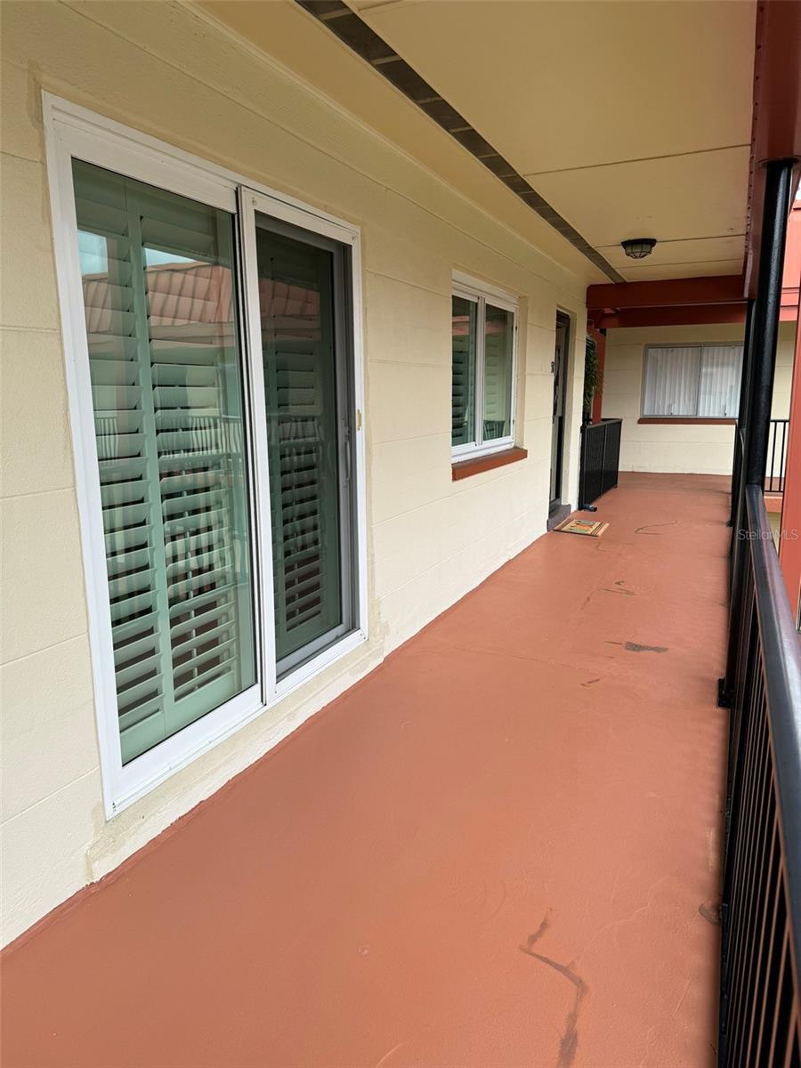 View of Dining Room Sliders, Living Room Window and Front Door