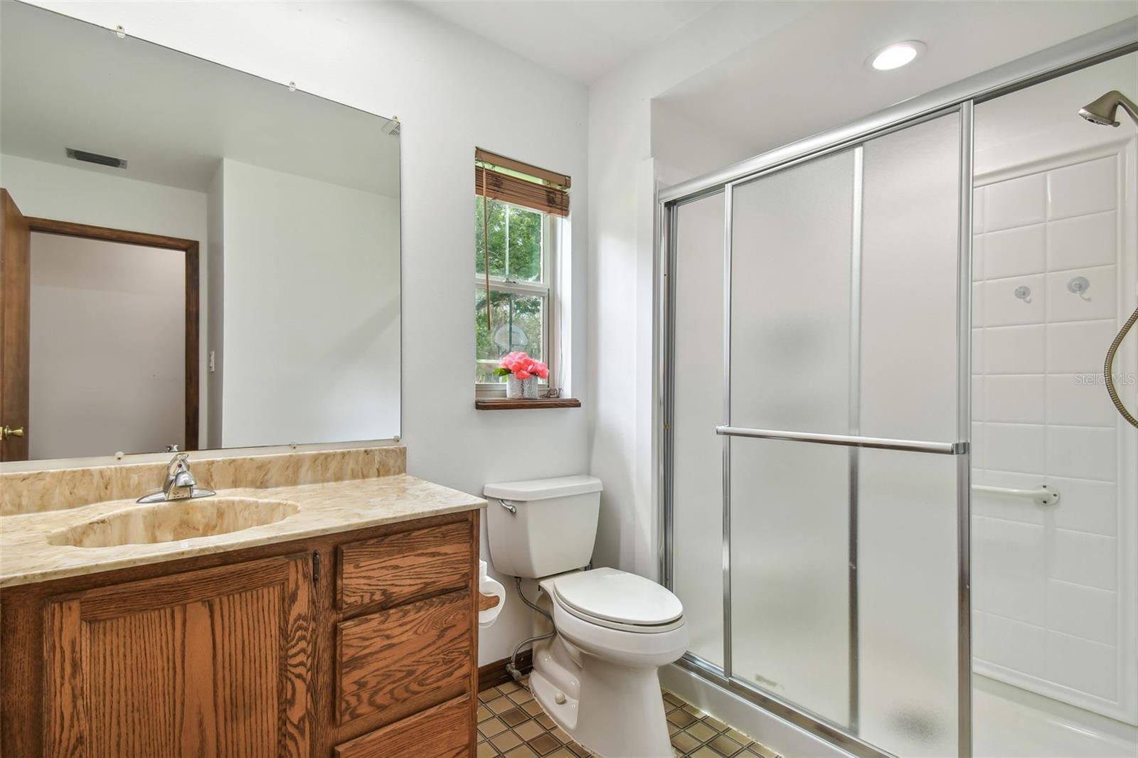 Secondary bathroom features a brand new shower.  Bathroom is situated in the private secondary hallway between bedrooms.