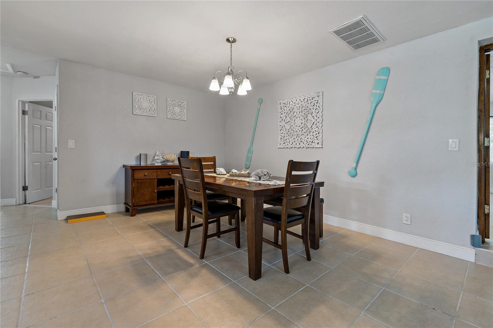 This space next to the kitchen is currently being utilized as a dining room, but is versatile.