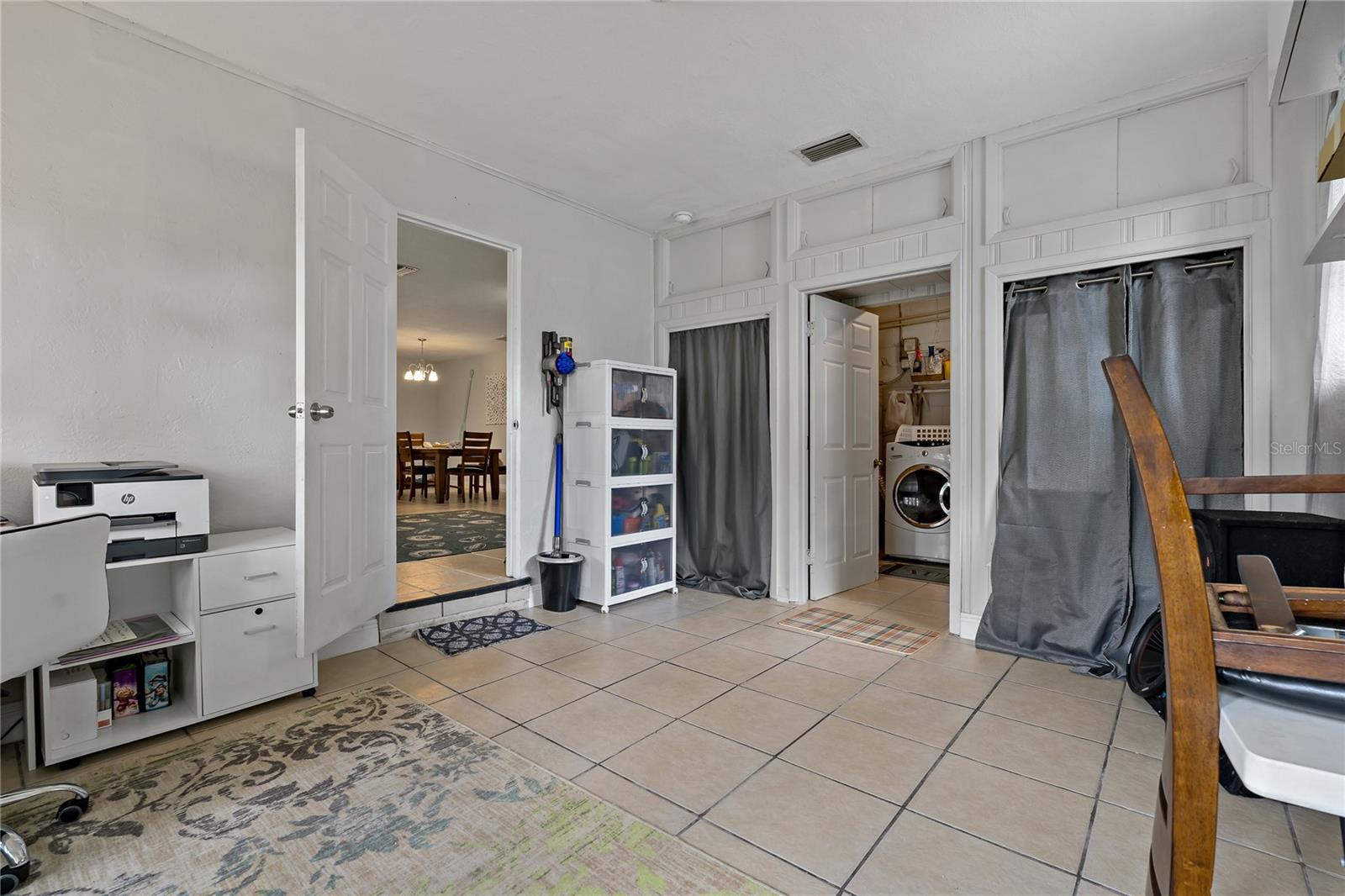 The 4th bedroom off the first living area includes a walk in laundry room.