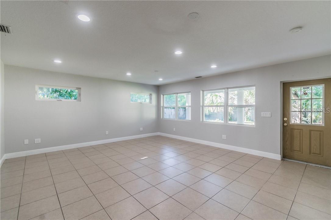 Spacious and bright bonus/Florida room looks out to the pool in the backyard.