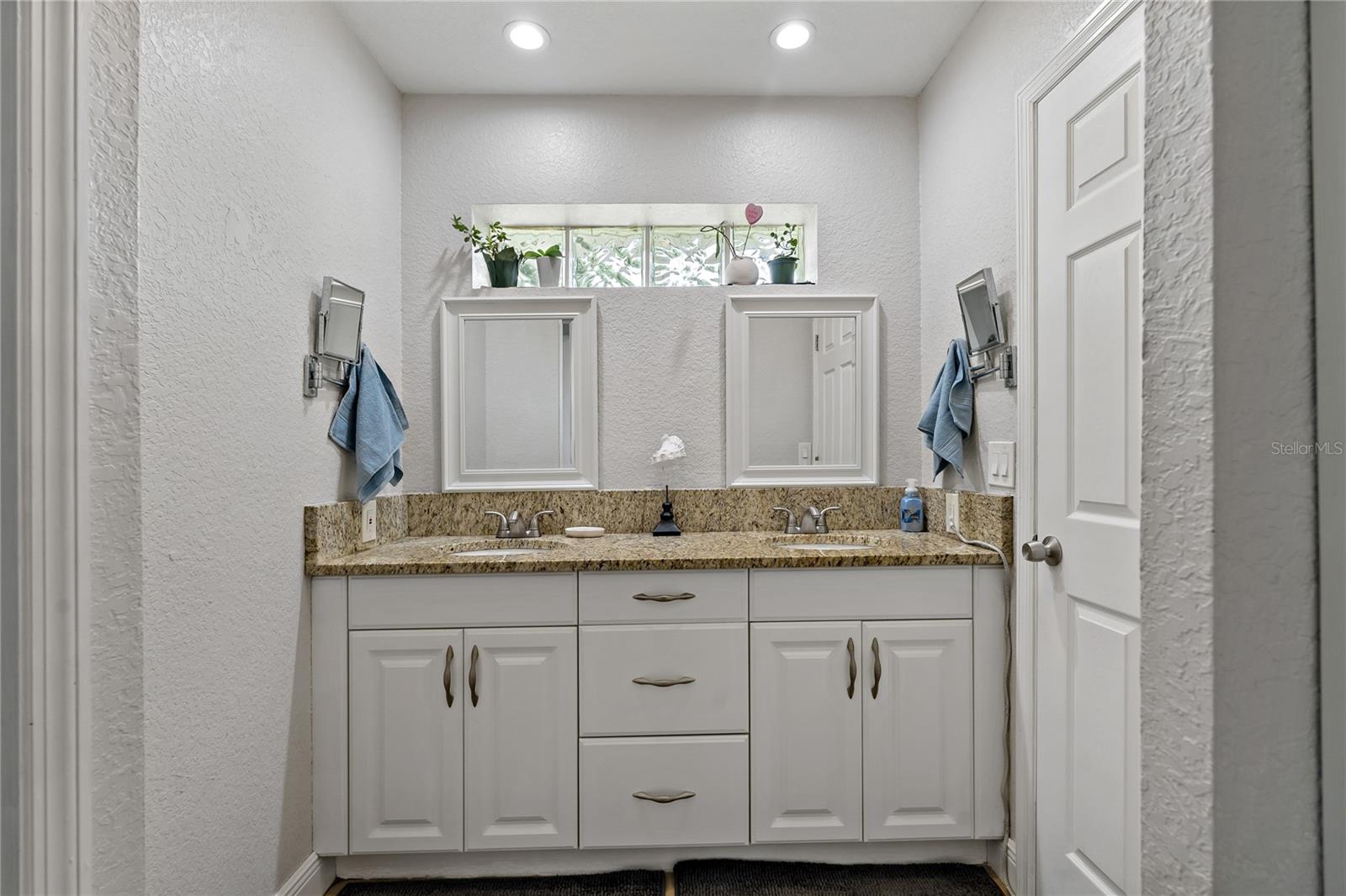 Updated tall master bath with twin sinks.