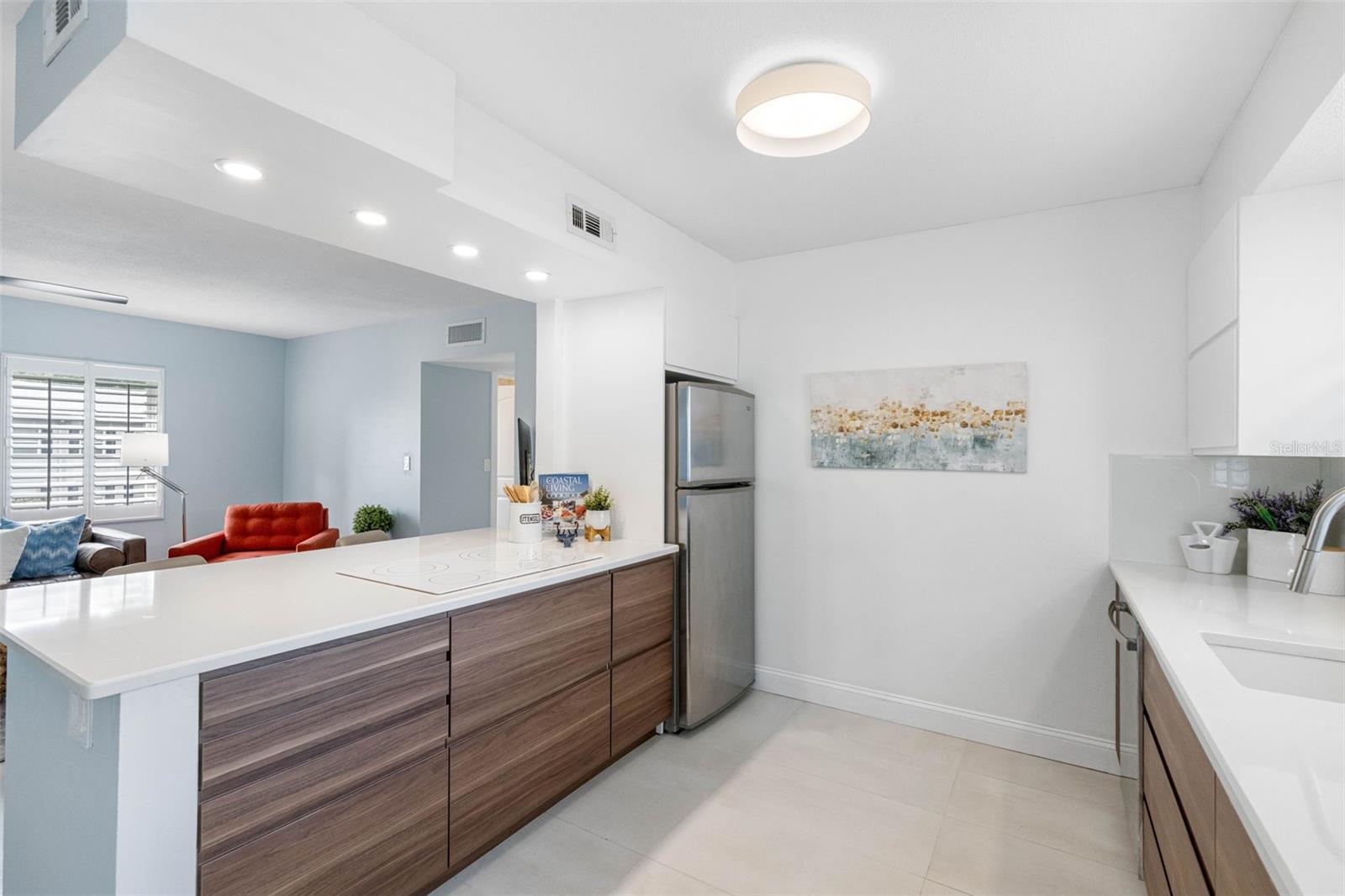 This kitchen exudes a modern and sleek aesthetic with its minimalist design.