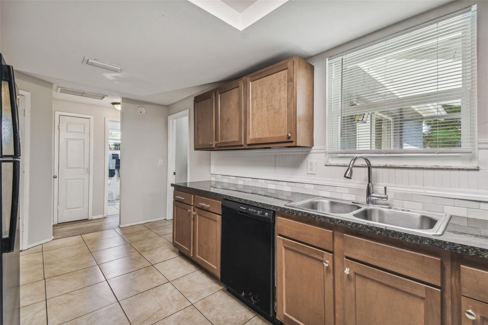 Kitchen with sink overlooking back yard