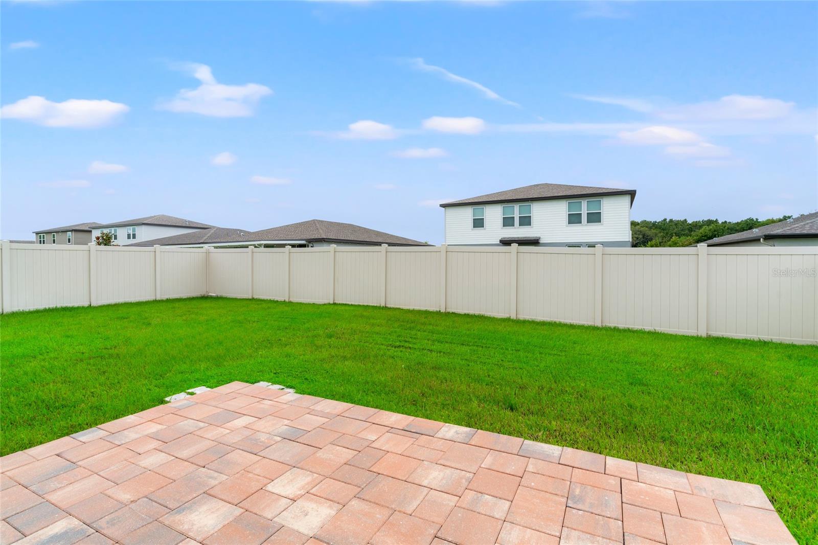 Lanai w/ brick pavers and fenced backyard