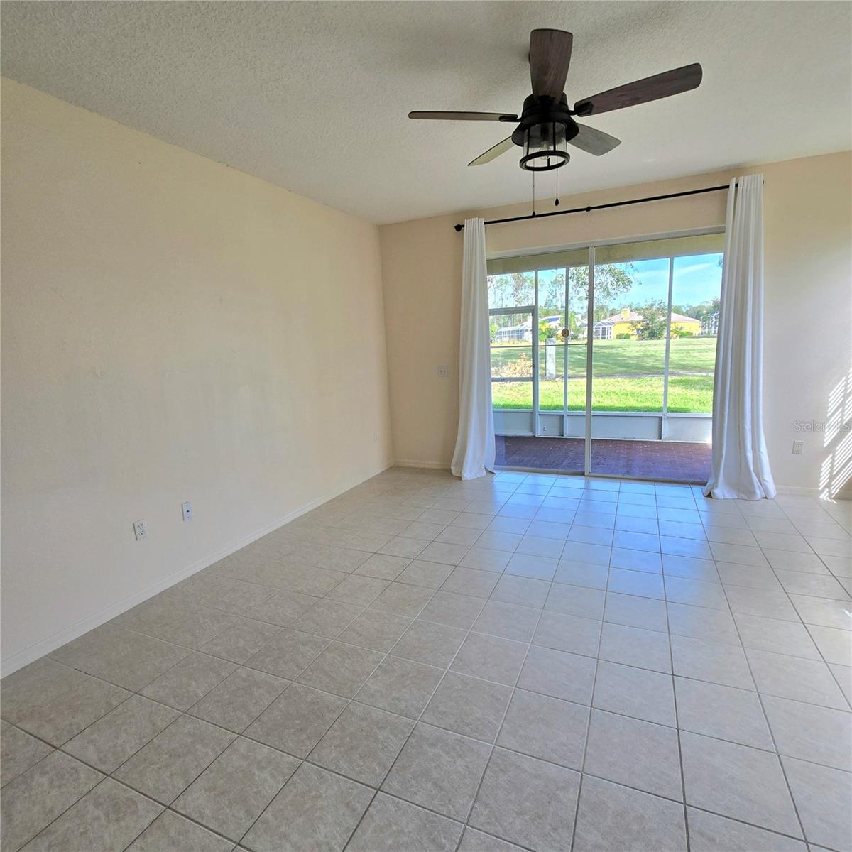 Living room overlooking patio and golf course