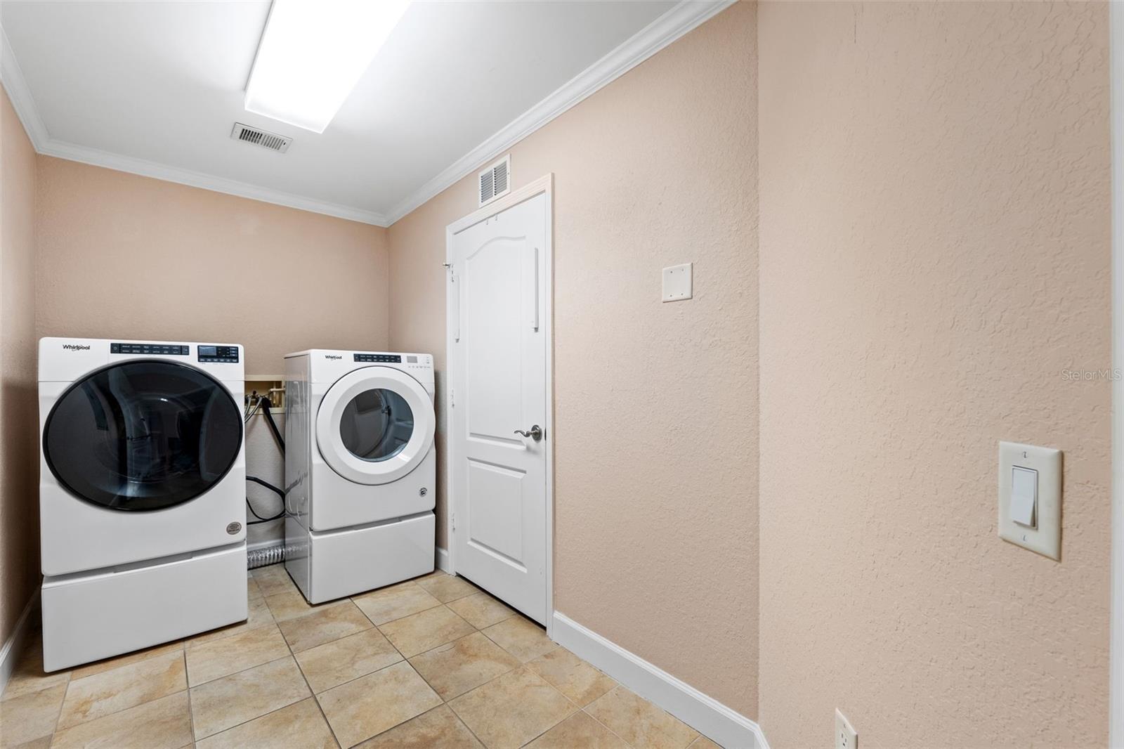 Large Laundry Room With Additional Walk In Closet For Storage.