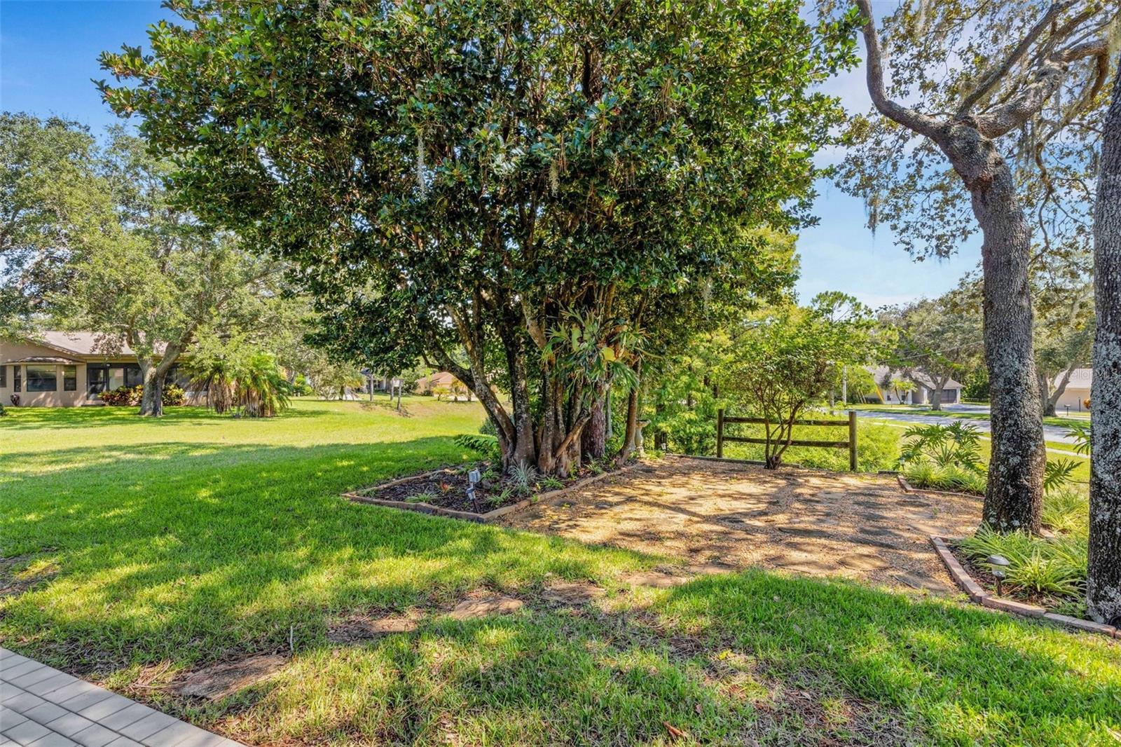 Rear patio off the sunroom with green views & privacy~