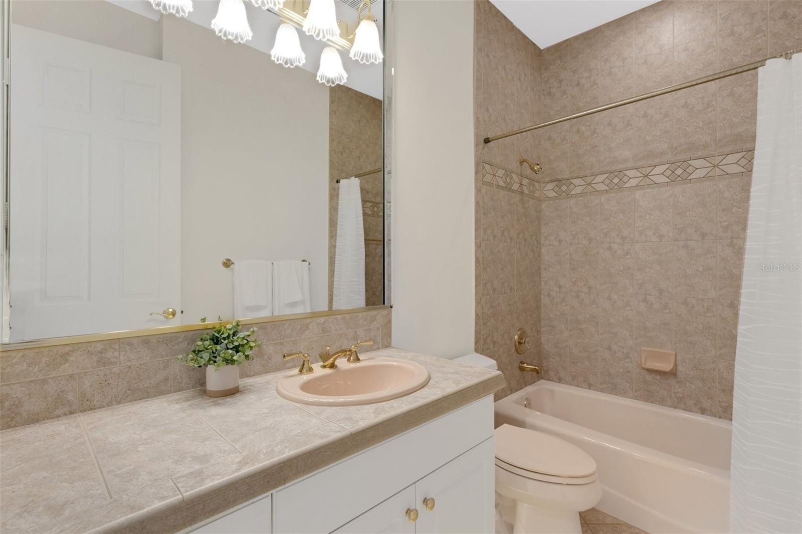 Guest bathroom with tub and shower