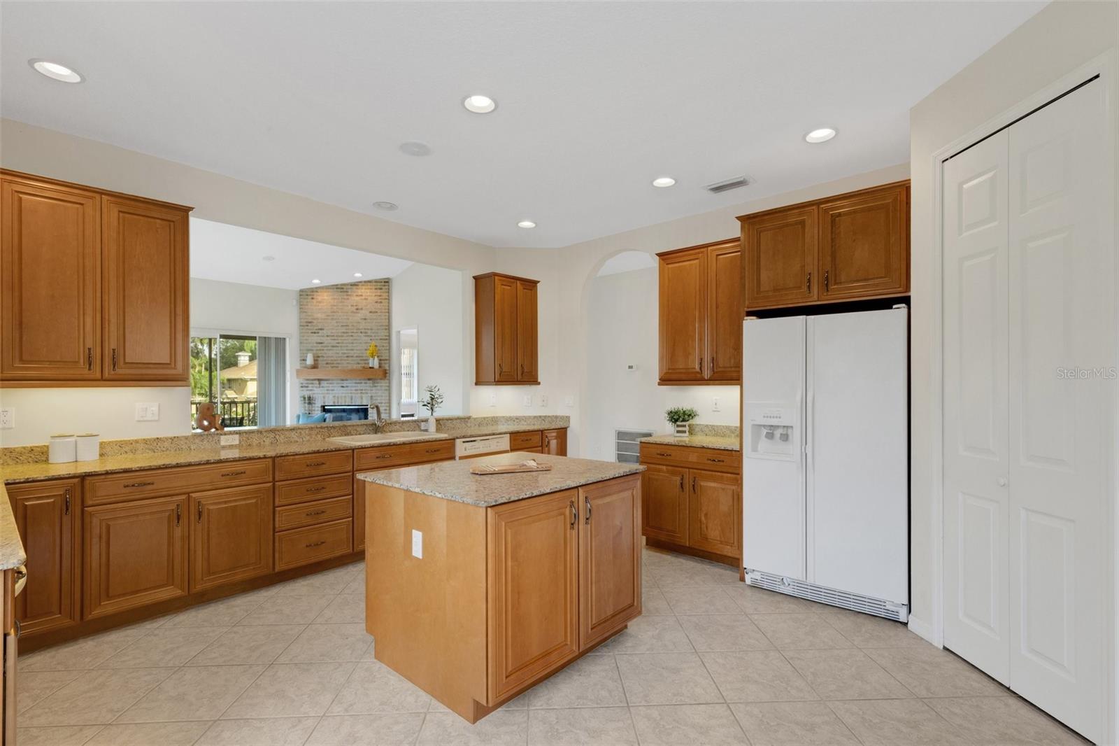 The eat-in kitchen has granite counters, wood cabinets, and a walk-in pantry!