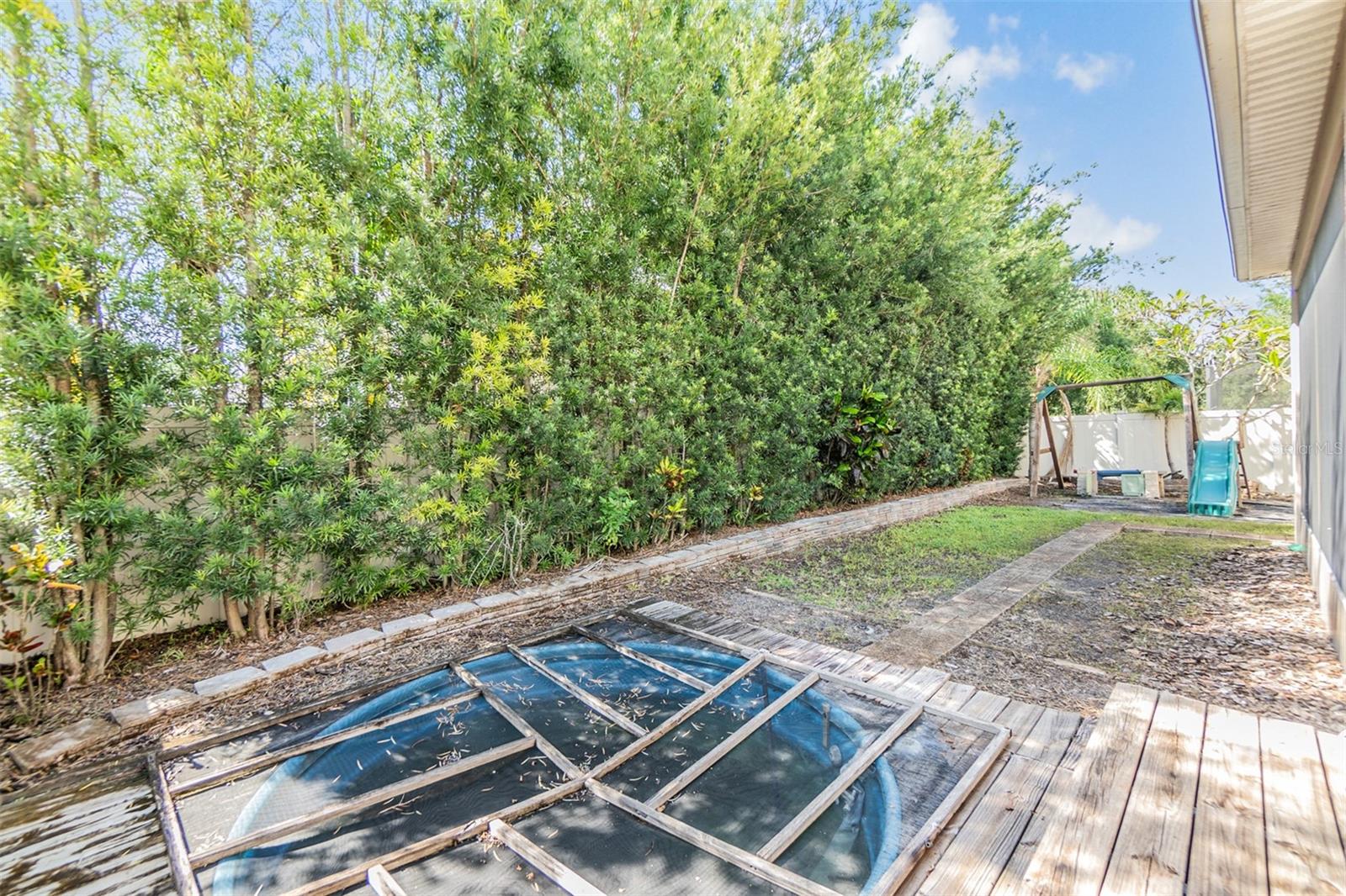 Back yard with former covered pool that can be removed