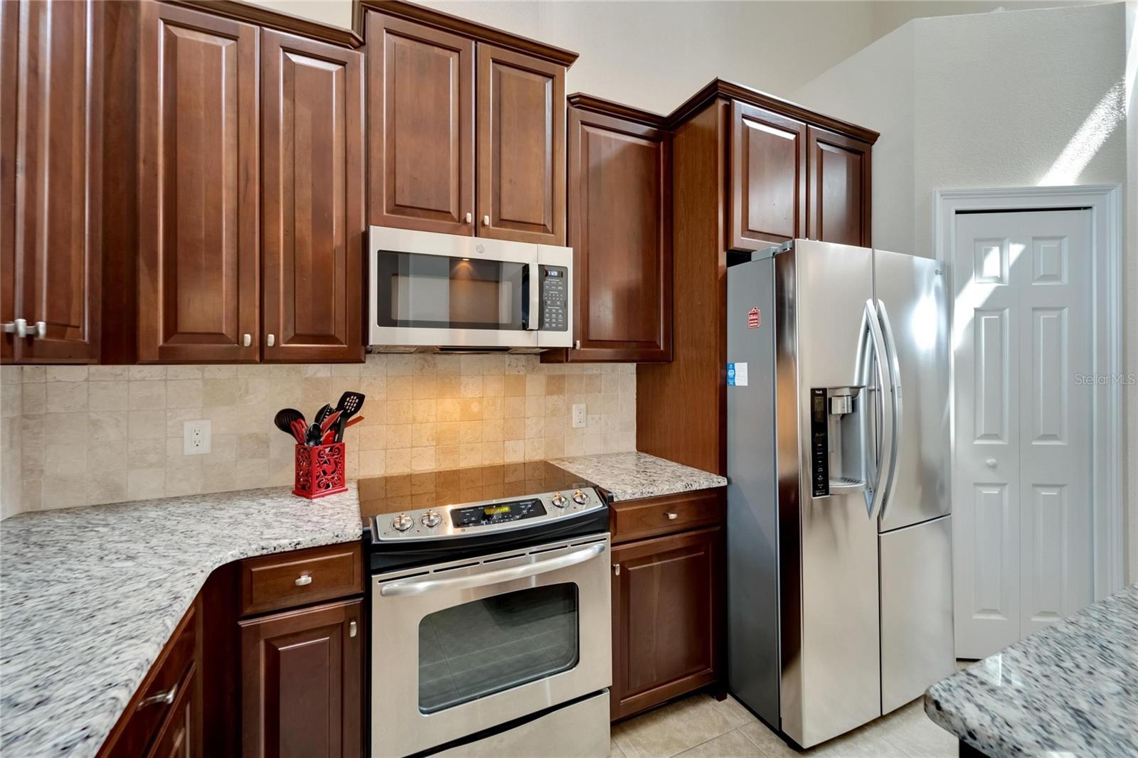 Kitchen: Granite Countertops, marble backsplash, 42 inch wood cabinets, and Pantry