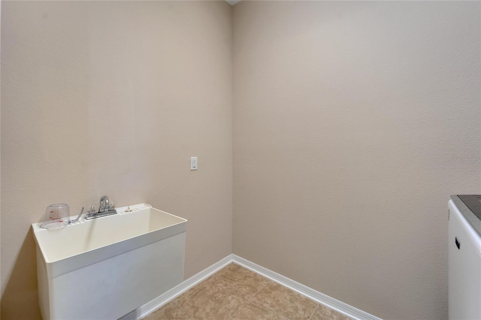 Laundry Room with washer, electric dryer, and utiliy tub