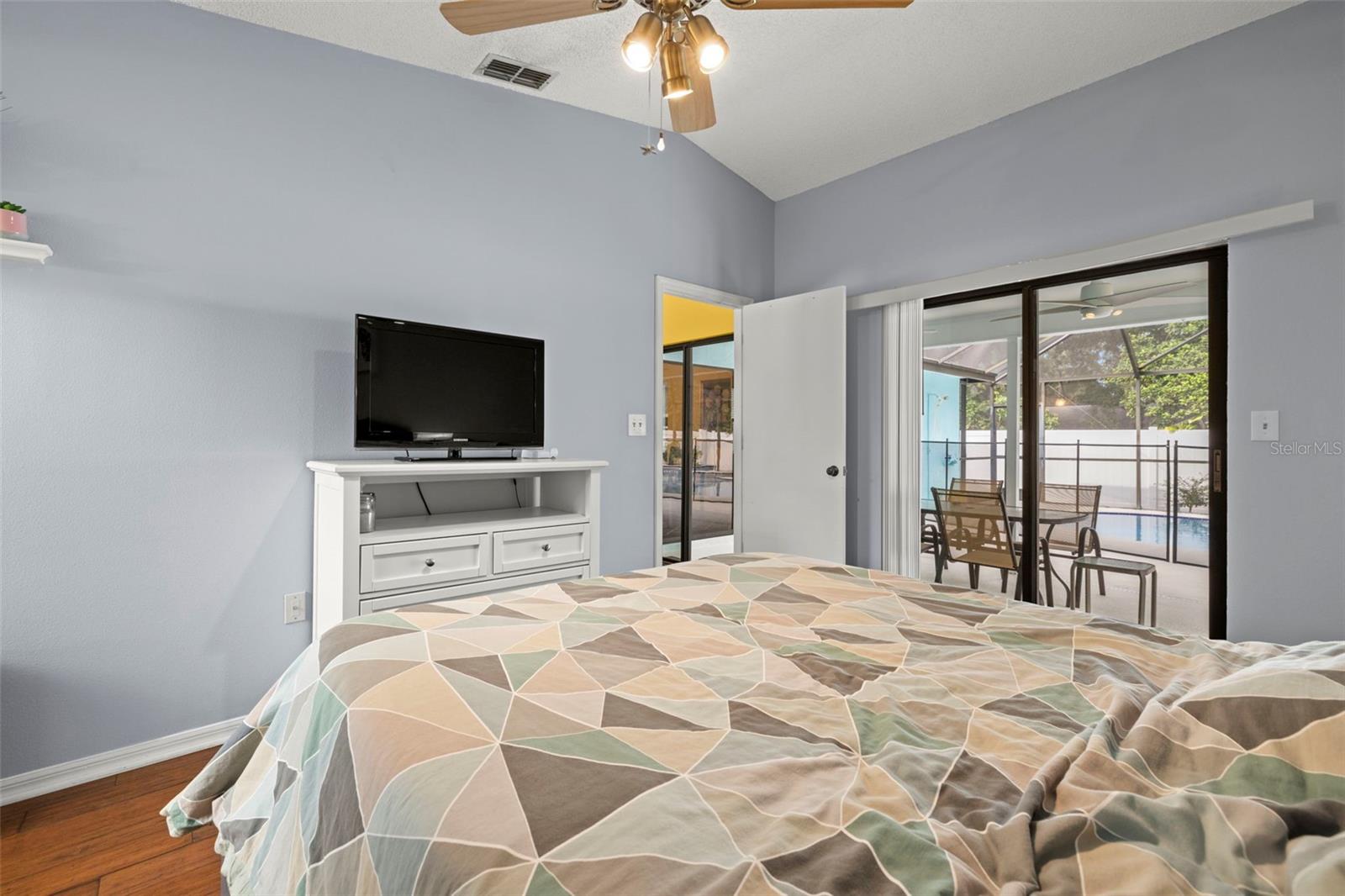 Primary bedroom with glass sliders to the patio