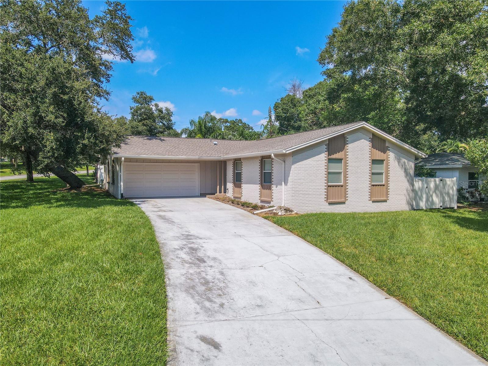 Tree Shaded, Corner lot,  Three-bedroom, Two-bath, two-car garage with an updated kitchen and bathrooms.