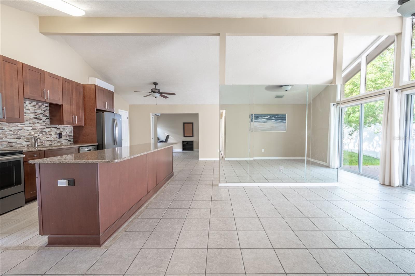 The open kitchen, living and dining areas have an abundance of natural light.