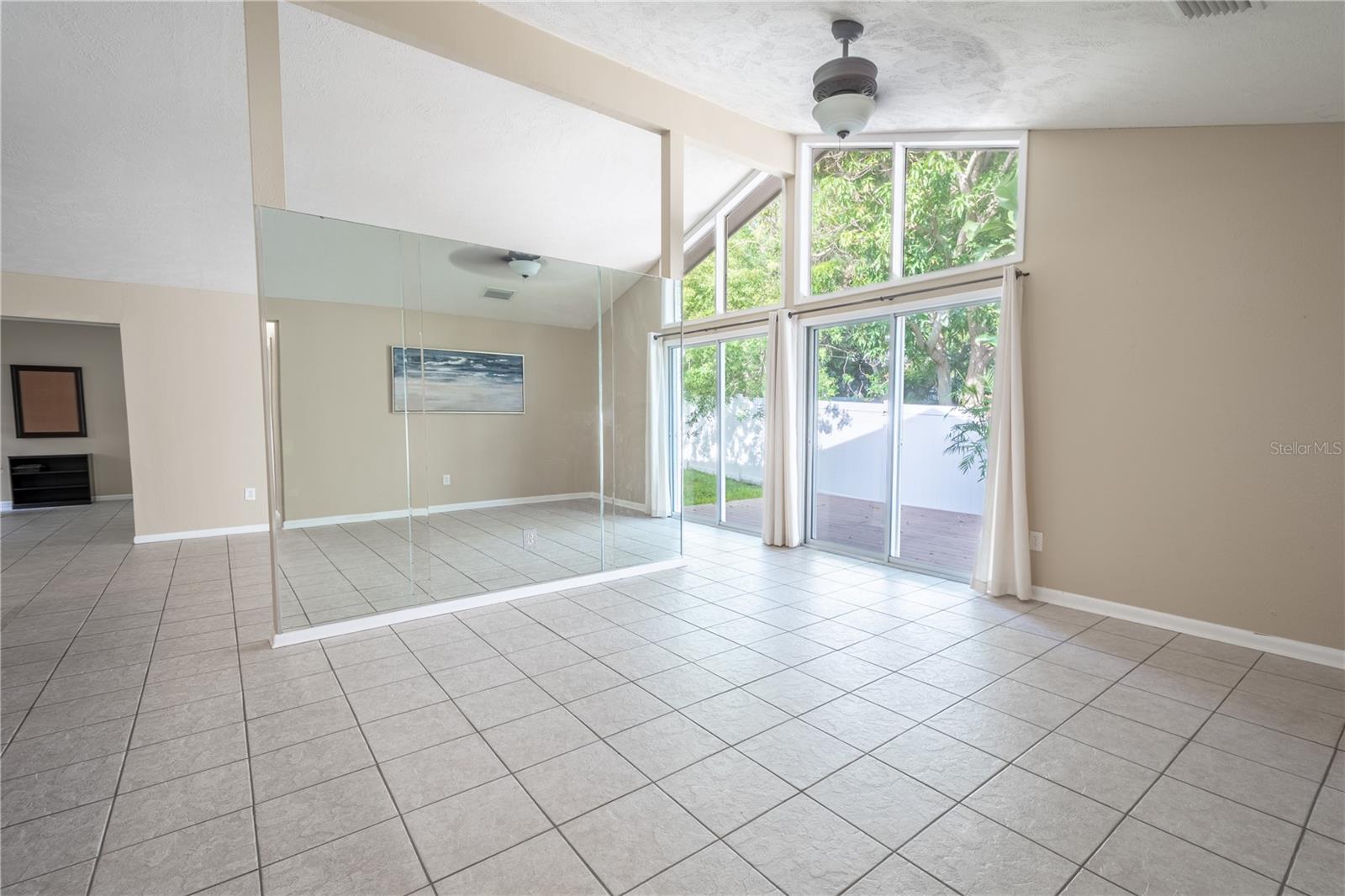 The living room features ceramic tile floors and a ceiling fan with light kit.