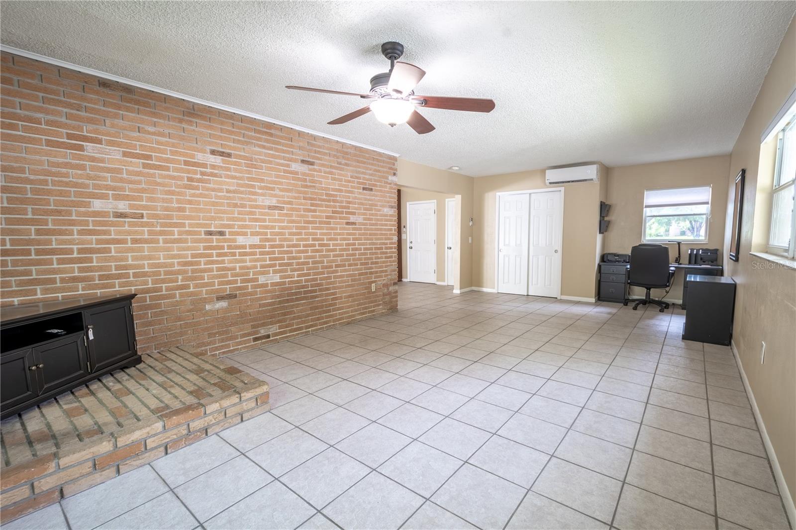 The family room features a charming brick accent wall.