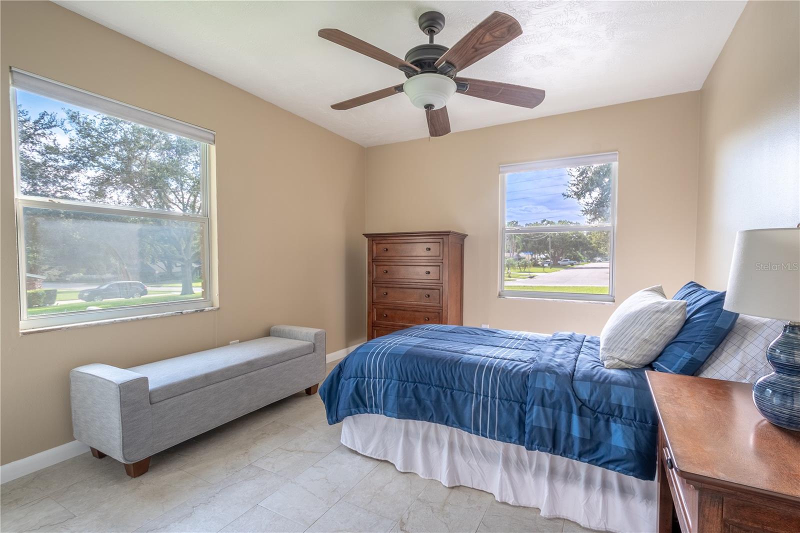 Bedroom 2 is 10'.10" x 14'.3" and has a ceiling fan with light kit.